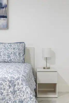 a bedroom with a bed and a nightstand with a lamp at Nice,Stylish King Bed Studio in Miami Gardens