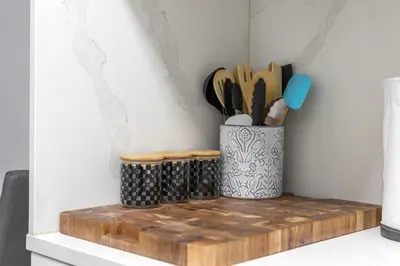a kitchen counter with a container of utensils at Nice,Stylish King Bed Studio in Miami Gardens