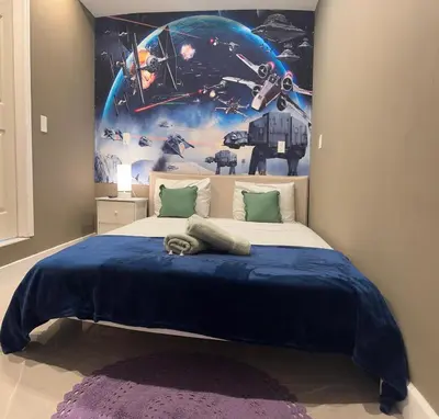a bedroom with a bed with a star wars mural at Miami Design District in Miami