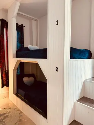 two bunk beds in a room with two shelves at Miami Design District in Miami