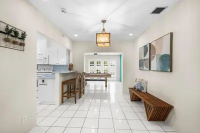 a kitchen and living room with a table and chairs at Beach Home Estate I Pool & Ocean in Fort Lauderdale