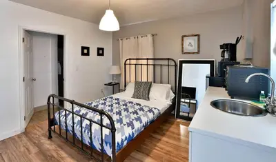 a bedroom with a bed with a sink and a counter at Krymwood Flats Wynwood in Miami