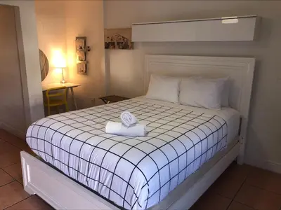 a bedroom with a bed with a towel on it at Krymwood Flats Wynwood in Miami