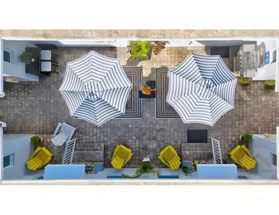 a rendering of a patio with three umbrellas at Sunlit Studio Escape Hollywood Haven, sleeps 4 in Hollywood