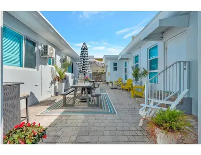 a patio with a table and benches on a building at Sunlit Studio Escape Hollywood Haven, sleeps 4 in Hollywood