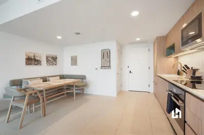 a kitchen and dining room with a table and chairs at Stylish Apartments with Partial Ocean Views in Downtown! in Miami