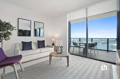 a living room with a couch and a table at Stylish Apartments with Partial Ocean Views in Downtown! in Miami