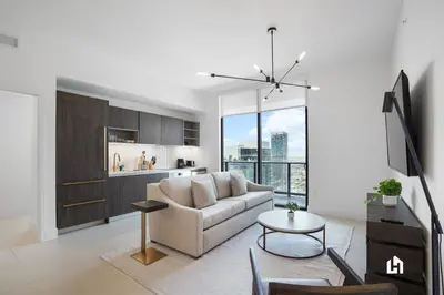 a living room with a couch and a table at Stylish Apartments with Partial Ocean Views in Downtown! in Miami