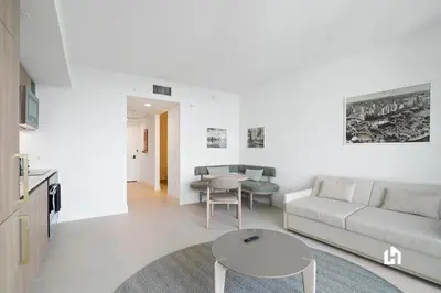 a living room with a couch and a table at Stylish Apartments with Partial Ocean Views in Downtown! in Miami