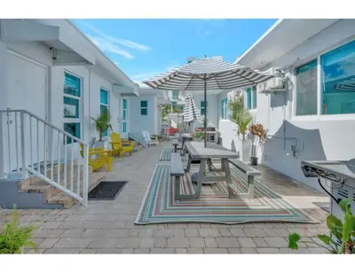 a patio with a table and an umbrella at Sunset Bliss Hollywood Seaside Studio Retreat in Hollywood