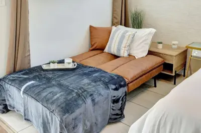 a living room with a couch and a table at Sandscape Haven Hollywood Beach Studio w Parking in Hollywood