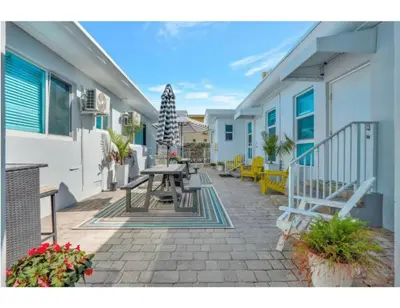 a patio with a table and benches on a building at Sandscape Haven Hollywood Beach Studio w Parking in Hollywood