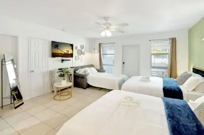 a bedroom with two beds and a living room at Hollywood Beach Escapade Studio with Free Parking in Hollywood