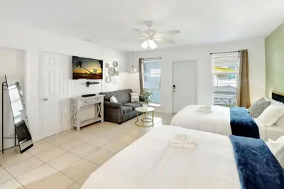 a living room with two beds and a couch at Hollywood Beach Escapade Studio with Free Parking in Hollywood