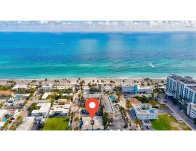an aerial view of a beach with a red marker at Coastal Retreat ONLY 1 block from the beach in Hollywood
