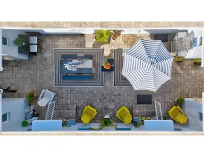 a rendering of a patio with two umbrellas at Sunny Serenity Hollywood Studio Getaway in Hollywood