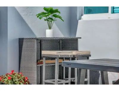 a table and chairs with a potted plant on a balcony at Sunny Serenity Hollywood Studio Getaway in Hollywood