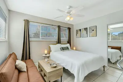 a bedroom with a bed and a couch at Beachside Bliss Hollywood Studio in Hollywood