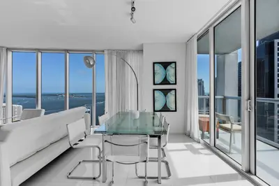 a living room with a couch and a glass table at Large Suites in Hotel W with bay views in Miami