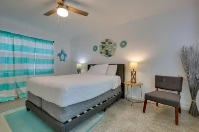 a bedroom with a bed and a chair at 3 Mi to Beach Quaint Home with Patio in Hollywood in Hollywood