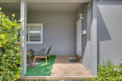 a porch with a chair and a window at 3 Mi to Beach Quaint Home with Patio in Hollywood in Hollywood