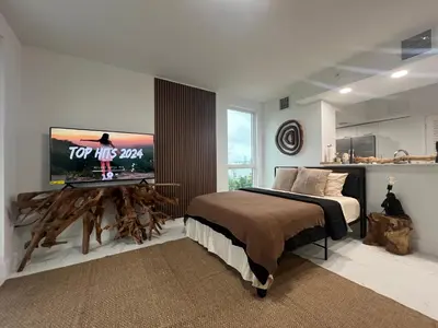 a bedroom with a bed and a tv on a wall at MIAMI WOOD APART HOTEL NEW 2024 - PRIVATE TERRACE - free GARAGE - Beach 5 min in Hollywood