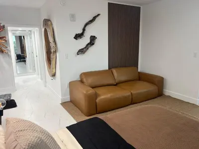 a living room with a brown leather couch in it at MIAMI WOOD APART HOTEL NEW 2024 - PRIVATE TERRACE - free GARAGE - Beach 5 min in Hollywood