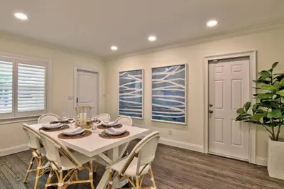 a dining room with a white table and chairs at Gorgeous Las Olas - Heated Pool, Close to Beach in Fort Lauderdale