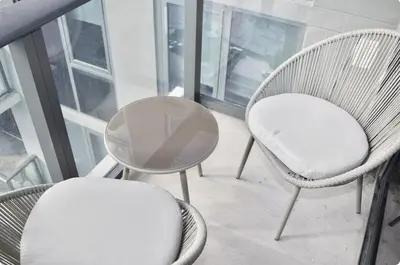 two chairs and a table on a balcony at The Bayfront III in Miami