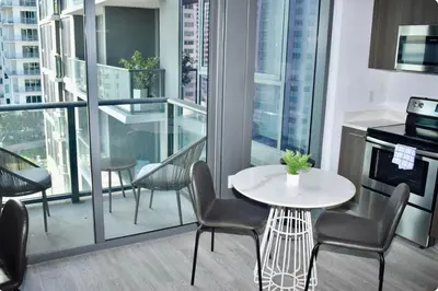 a kitchen with a table and chairs on a balcony at The Bayfront III in Miami