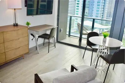a living room with a couch and a table and chairs at The Bayfront III in Miami