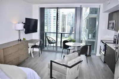 a living room with a bed and a table and chairs at The Bayfront III in Miami