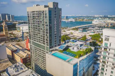 an aerial view of a tall building with a pool at The Bayfront III in Miami