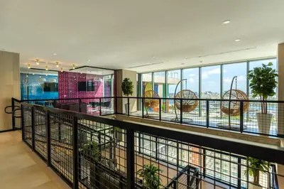 a large building with a balcony with plants at The Bayfront III in Miami