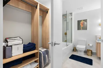 a bathroom with a toilet and a glass shower door at Luxury Panoramic Views - The Ultimate Downtown Getaway in Miami