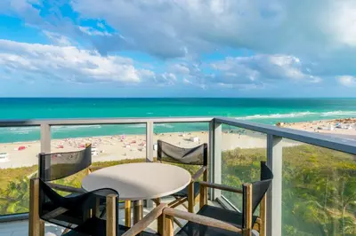 a balcony with a table and chairs and the beach at Oceanfront 3B Private Residence at South Beach - 828 in Miami Beach