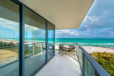 a balcony with views of the beach and the ocean at Oceanfront 3B Private Residence at South Beach - 828 in Miami Beach