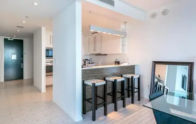 a kitchen with a counter and stools in a room at Oceanfront 3B Private Residence at South Beach - 828 in Miami Beach
