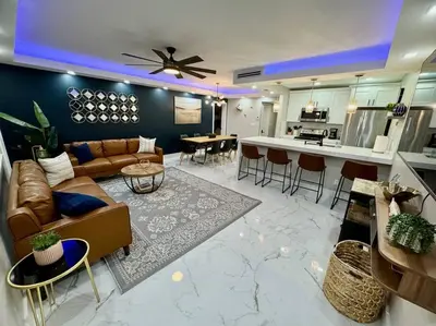 a living room with a couch and a kitchen at 3Bd 2Bath 1 Block from the beach! Newly renovated in Fort Lauderdale