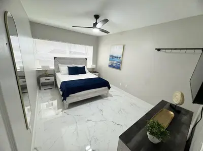 a bedroom with a bed and a ceiling fan at 3Bd 2Bath 1 Block from the beach! Newly renovated in Fort Lauderdale