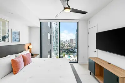 a bedroom with a bed and a flat screen tv at New Luxury 26th Floor Apartment in the heart of Miami in Miami