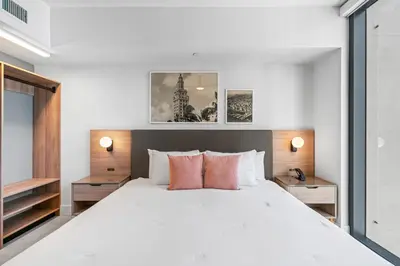 a bedroom with a large white bed with orange pillows at New Luxury 26th Floor Apartment in the heart of Miami in Miami