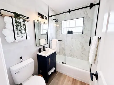 a bathroom with a toilet and a sink and a shower at AQUAMARIA HOME - perfect stay for groups in Fort Lauderdale