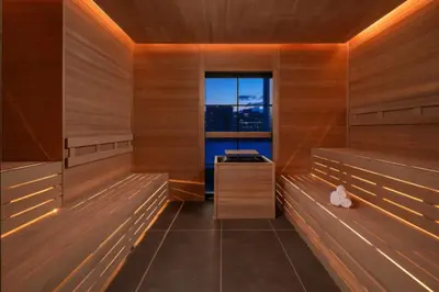 a sauna with wooden walls and a window at 49th Floor Sleek Condo Cozy Pool, Gym and Spa Stay in Miami