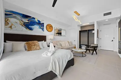 a bedroom with a large bed and a living room at PH 49 Floor Luxury Studio w Free Parking in Miami