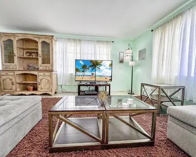 a living room with a couch and a coffee table at Sunrise Delight 2 min walk to Beach Essentials in Hollywood