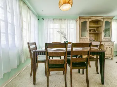 a dining room with a wooden table and chairs at Sunrise Delight 2 min walk to Beach Essentials in Hollywood