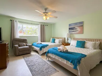 a bedroom with two beds and a ceiling fan at Sunrise Delight 2 min walk to Beach Essentials in Hollywood