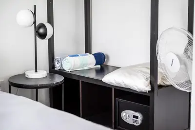 a room with a bed and a desk with a fan at The Netherland 2A I Ocean Drive I MIAMI BEACH OCEAN RENTAL in Miami Beach