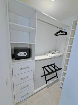 a white closet with a tv and a shelf at Sleek New Brickell Condo With Free Parking - CS65 in Miami